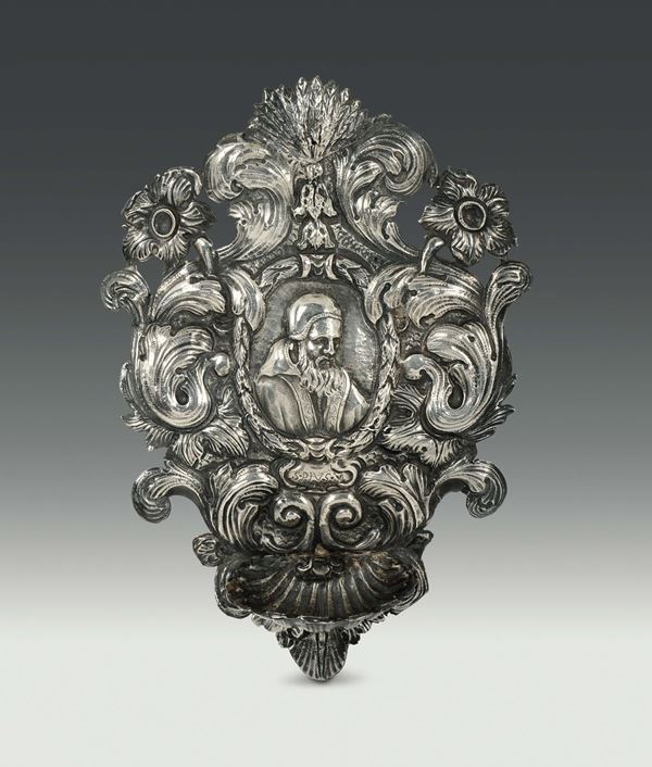 A holy water font in embossed and chiselled silver, Genova, end of the 17th century