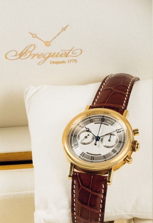 BREGUET, Rattrappante, Ref. 5947. Very fine and rare, 18K yellow gold wristwatch with round and oval button split-seconds chronograph, register and an 18K yellow gold Breguet deployant clasp. Accompanied by the original box, papers and Guarantee. Made in 2005.