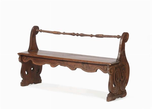 Bench in polished and carved walnut wood. Central Italy, 17th century