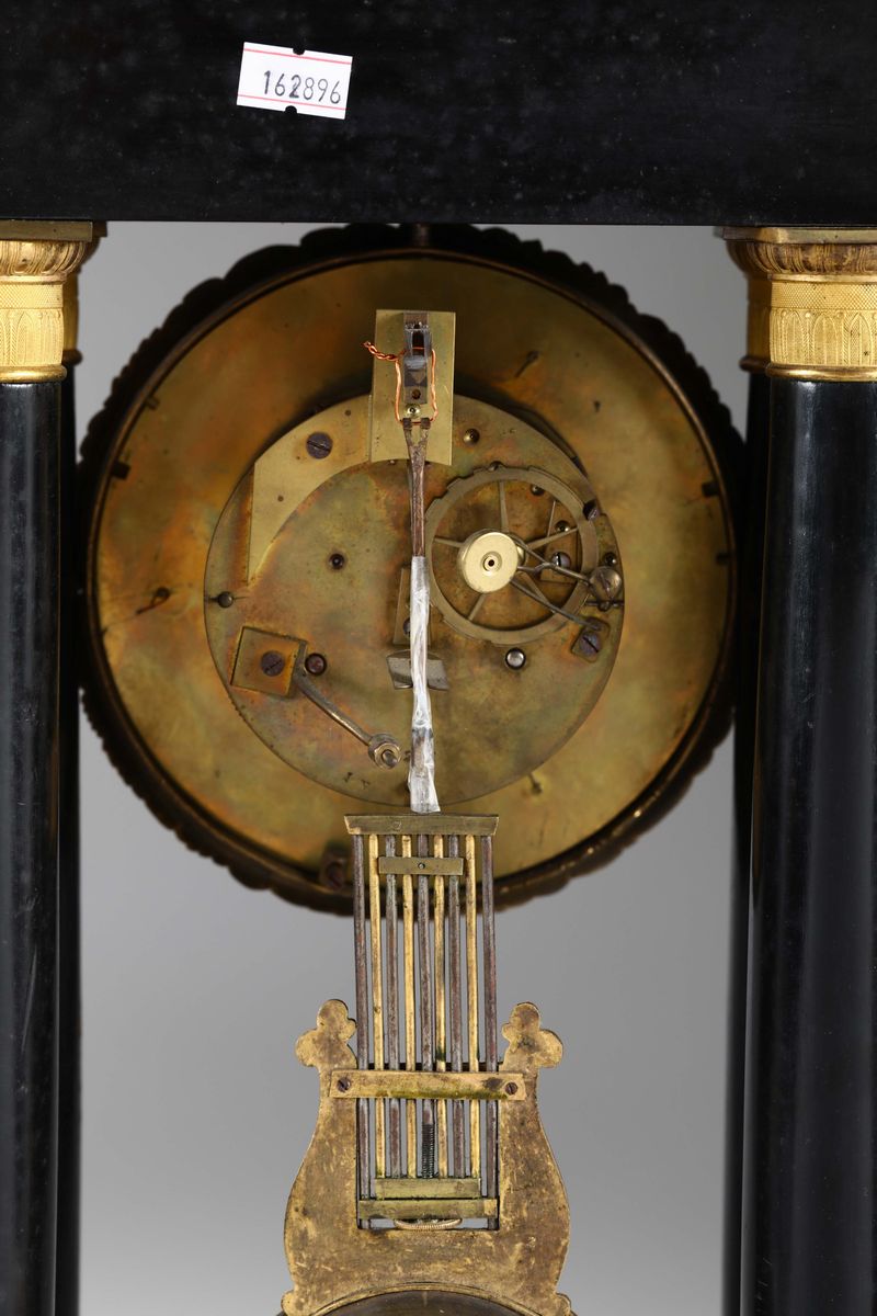 Due Orologi con Cassa in Legno Ebanizzato e Applicazioni in Bronzo Dorato, Francia XIX Secolo
