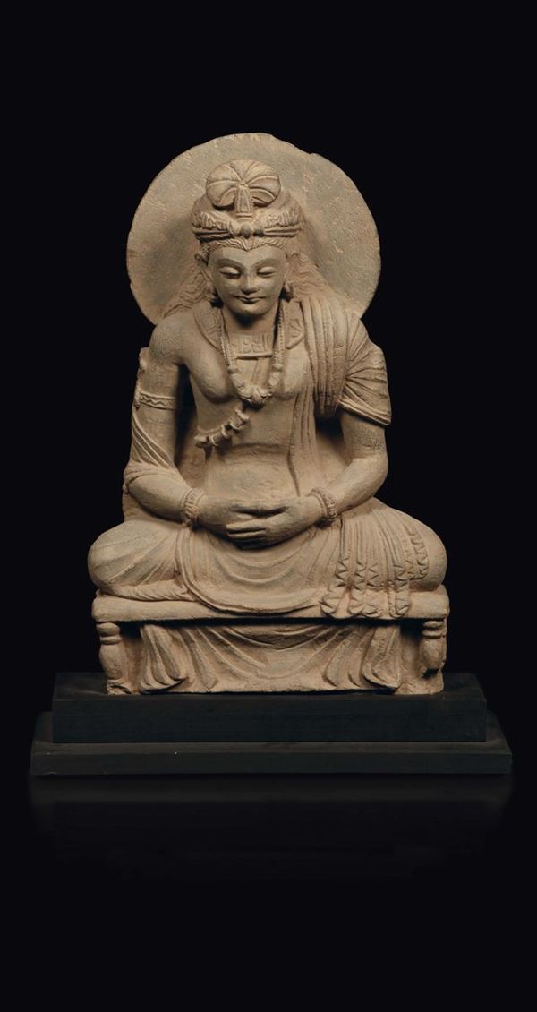 A schist figure of a seated Buddha with aura, Gandhara 3rd/4th century