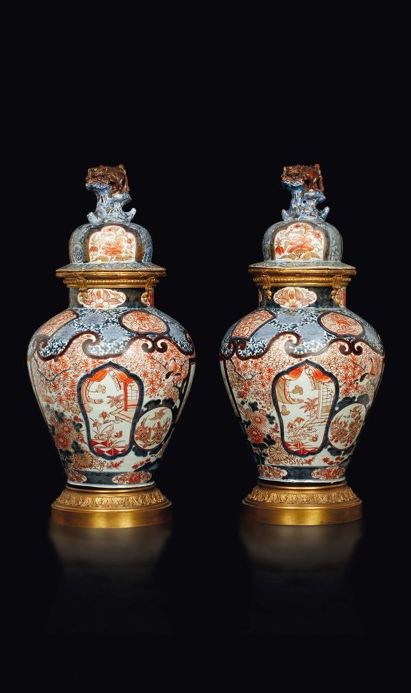 A pair of Imari Arita porcelain potiches and cover with gilt bronze base and details, Japan, 18th century