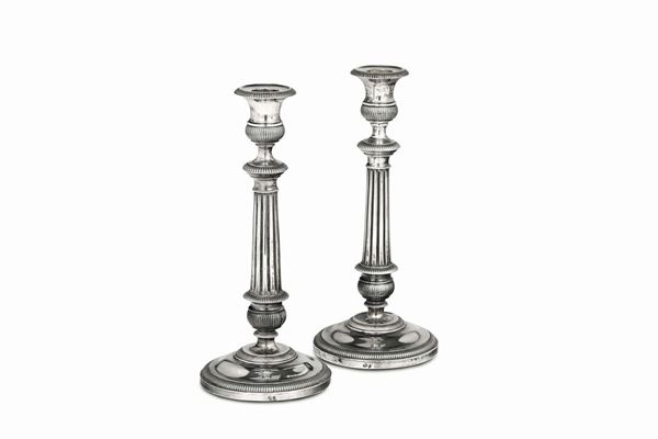 A pair of candlesticks in embossed, molten and chiselled silver, Genova, beginning of the 19th century, guarantee marks (dolphin and Mauritian cross).