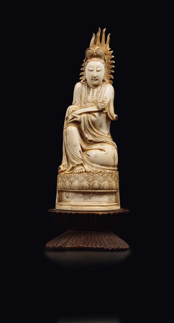 A carved ivory figure of Guanyin with aura and ruyi seated on a lotus flower, China, Qing Dynasty, 19th century