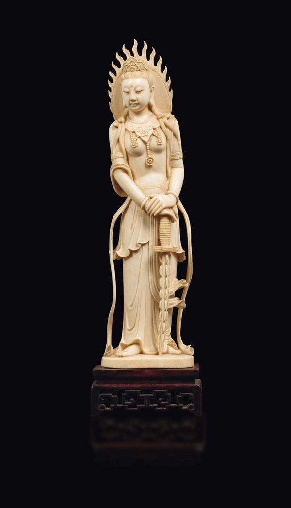 A carved ivory figure of Guanyin with aura and a sword, China, early 20th century