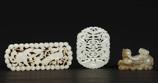 Three carved white jades, a pendant, a Pho dog and a fretworked one with birds, China, 20th century