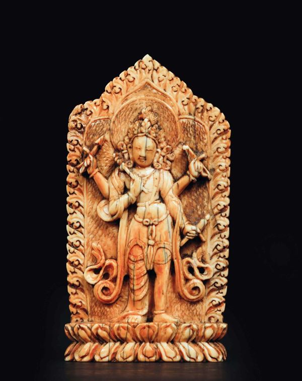 A carved ivory plaque with deity on a lotus flower with ritual instruments in his hands, china, Ming  [..]
