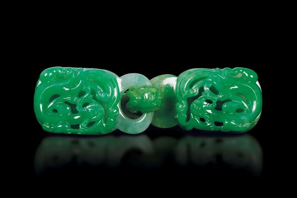 A fine Imperial emerald green shades jadeite belt buckle, China, 19th/20th century