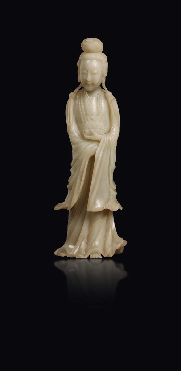 A white jade figure of standing Guanyin with scroll, China, Qing Dynasty, Qianlong Period (1736-1795)