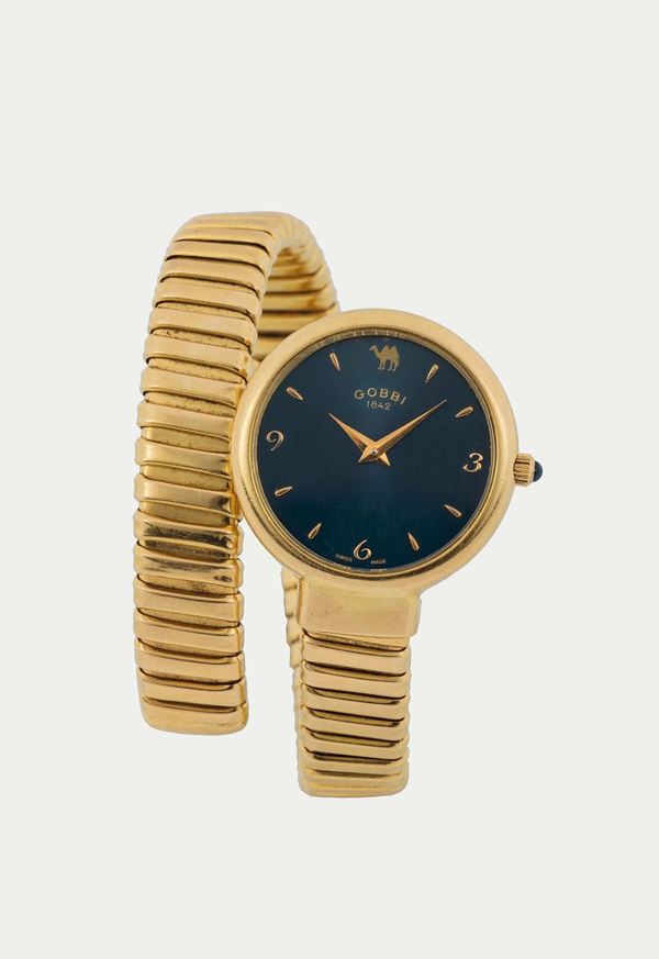 GOBBI, Ref. 57100, orologio da polso, da signora, al quarzo,  in oro giallo 18K con bracciale integrato in oro. Realizzato nel 1980 circa