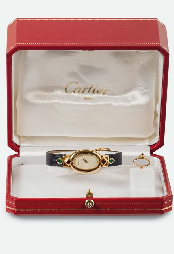 CARTIER, Swiss, MINI BAIGNOIRE, elegant, 18K yellow gold lady's quartz wristwatch with emeralds,  rubies and an original gold deployant clasp. Accompanied by the original box and key for the hour setting. Made circa 1990