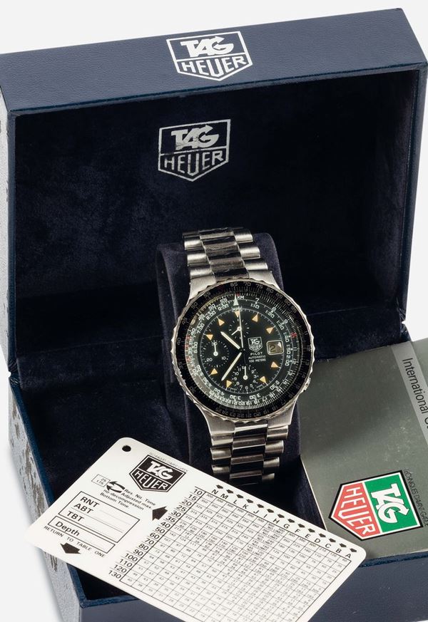TAG HEUER, Pilot Automatic 100 Meter First Generation, self-winding, water resistant, stainless steel chronograph wristwatch with date, slide rule  and an original steel bracelet with deployant clasp. Accompanied by the original box, hang tag and Guarantee. Made circa 1980.