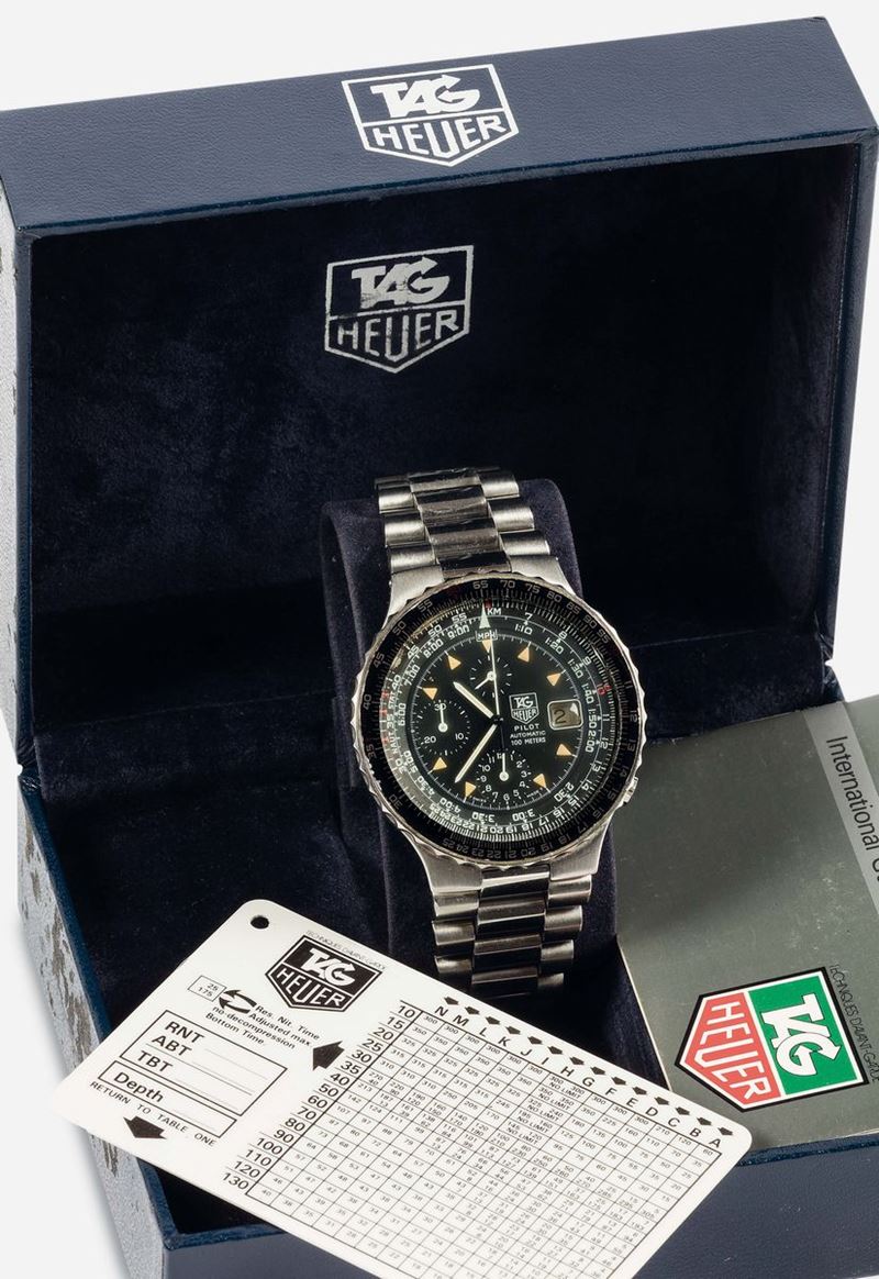 TAG HEUER, Pilot Automatic 100 Meter First Generation, self-winding, water resistant, stainless steel chronograph wristwatch with date, slide rule  and an original steel bracelet with deployant clasp. Accompanied by the original box, hang tag and Guarantee. Made circa 1980.  - Auction Watches and Pocket Watches - Cambi Casa d'Aste