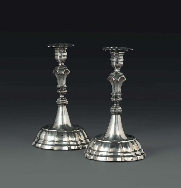 A pair of small candle holders in embossed and chiselled silver, Reggio Emilia, 18th century, Community stamp and unidentified goldsmith's mark