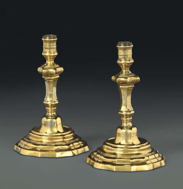 A pair of candle holders in embossed, chiselled and gilt silver, Rome, second quarter of the 18th century,  worn out Roman cameral stamp and another unreadable stamp.