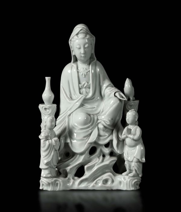 A sitting Guanyin with young boys in Blanc de Chine porcelain, China, Qing dynasty, 19th century