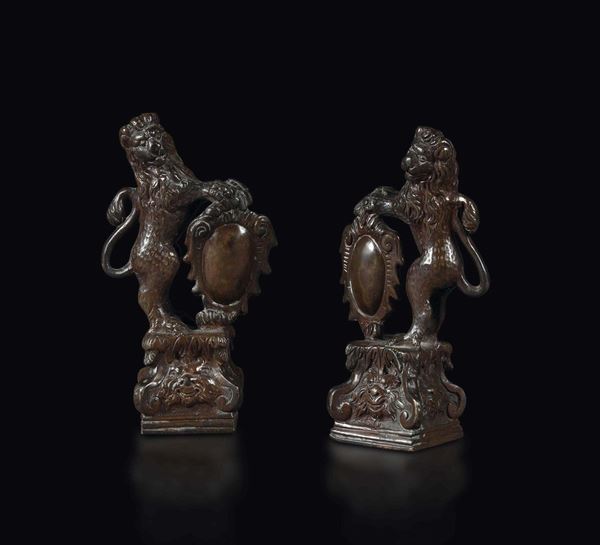 A pair of bronze lions with coats of arms, 19th century