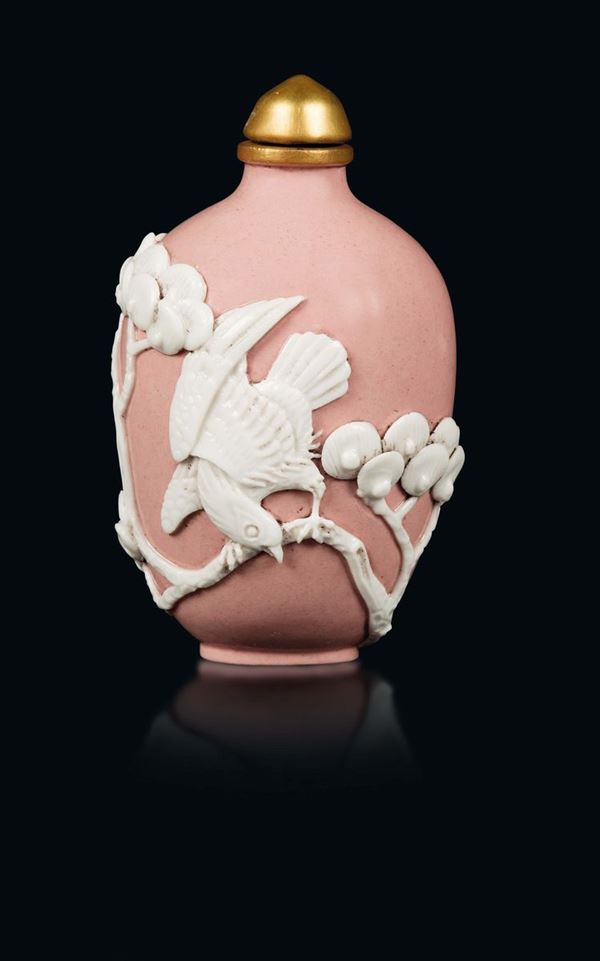 A pink-ground porcelain snuff bottle with birds in relief, China, 20th century