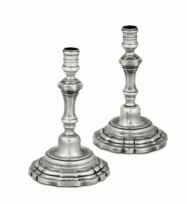 A pair of candlesticks in embossed and chiselled silver, Rome, 18th century, cameral mark and other worn-out mark