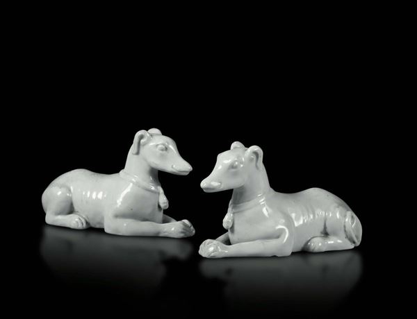 A pair of crouching hounds in Blanc de Chine porcelain, China, Qing dynasty 19th century