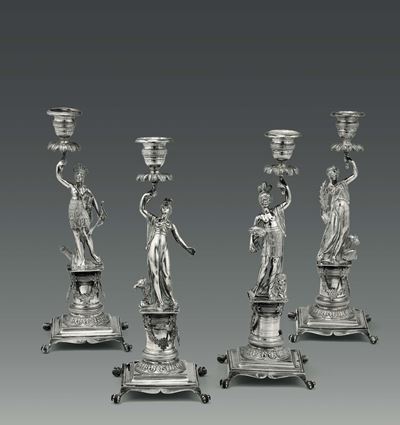 Gruppo di Quattro Candelieri Raffiguranti i Quattro Continenti in Argento Fuso, Sbalzato e Cesell...