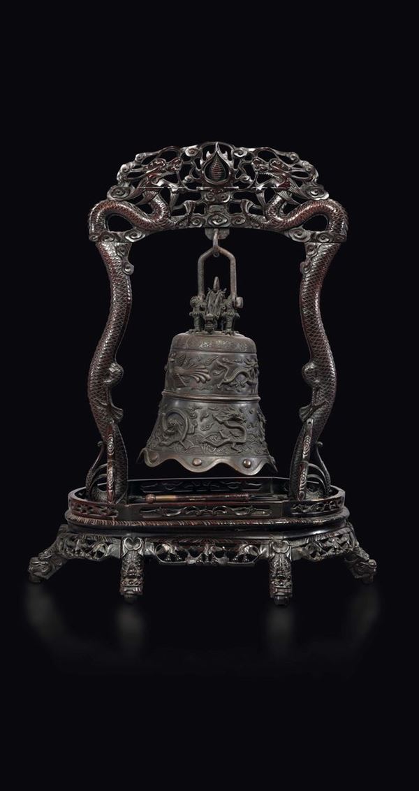 A large bronze bell with dragons and phoenixes on a wooden stand, China, Qing Dynasty, 18th century