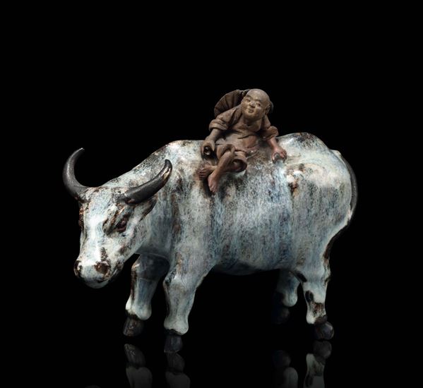 A glazed stoneware figure of a child on a buffalo, China, Qing Dynasty, 19th century