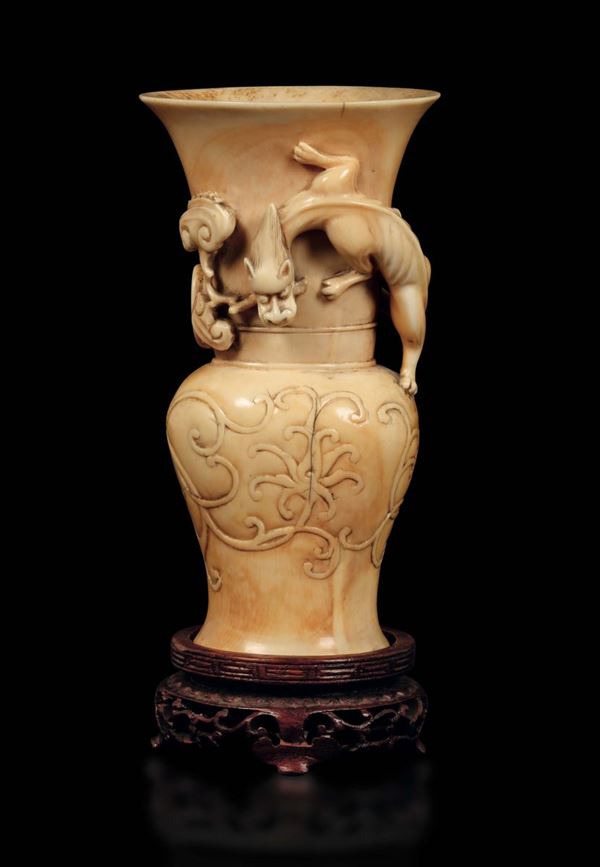 A carved ivory vase with fantastic animal in relief, China, Qing Dynasty, 19th century