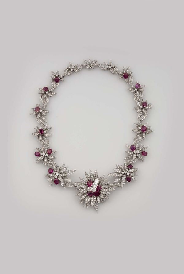 Settepassi, Florence. A platinum, diamond and ruby necklace.The central piece can be worn as a brooch and the two lateral flowers as earrings.1940s. Boxed.