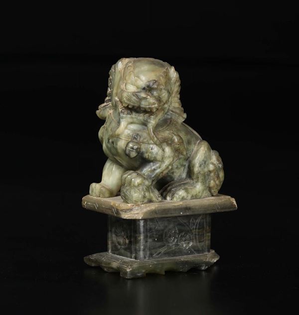 A green and russet jade figure of Pho dog, China, 20th century