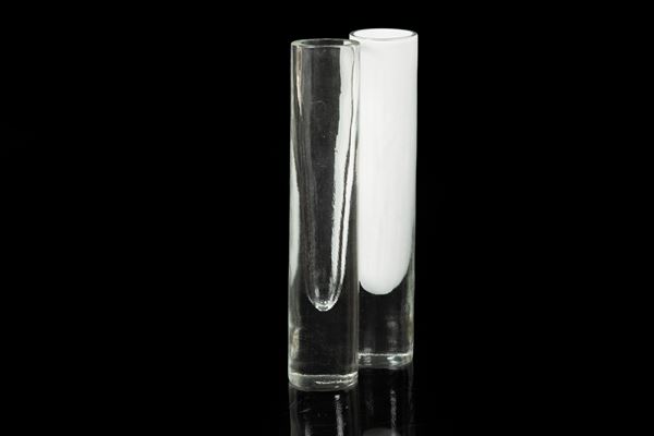 Vetreria Alfredo Barbini, Murano, 1970 ca. A pair of cylindrical vases in submerged blown glass, one clear, the other in milk glass