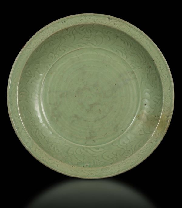 A large Longquan Celadon dish with naturalistic decoration, China, early Ming Dynasty