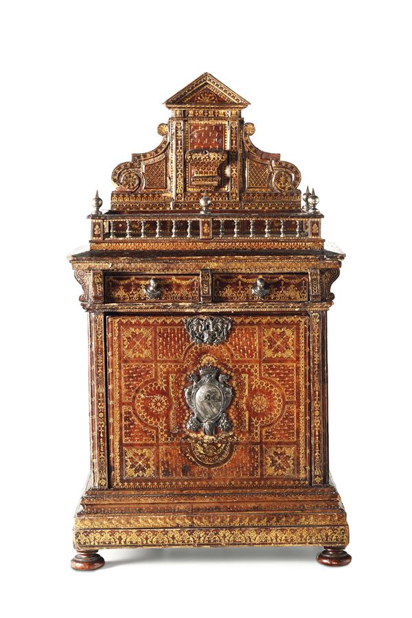 A table coin cabinet in an architectural style, coated in etched leather with gold decors. Germany or Netherlands, 17th-18th century