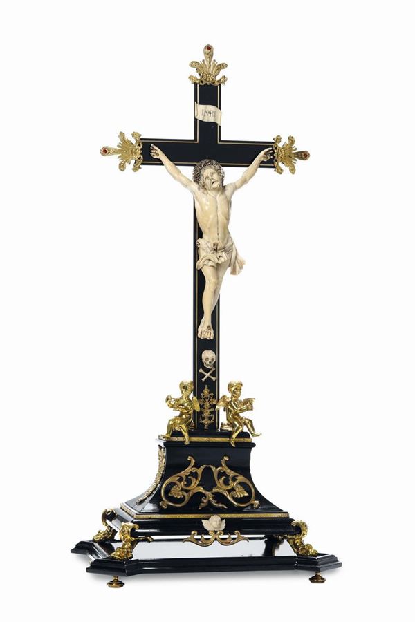 An important crucifixion in ebanised wood, carved ivory, molten, chiselled and gilded bronze and coloured stones. Flemish artist active in the 17th century