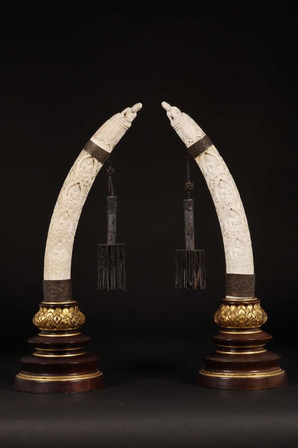 A pair of carved ivory with figures of Buddha, Burma, early 20th century