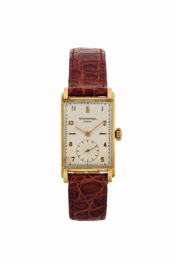 Patek Philippe & Cie, Genève, No. 838893, case No. 645619, Ref. 1559. Fine rectangular curved, 18K yellow gold  wristwatch. Made circa 1946. Accompanied by the original box and Exctract