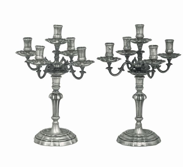 A pair of five-flame candle holders in molten and chiselled silver. Silversmith Buccellati, title stamps with fasces in use from 1935 to 1945.