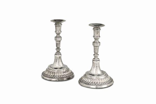 A pair of candle holders in embossed and chiselled silver, Milan, end of the 18th century, unidentified silversmith's mark (Saint Peter?).