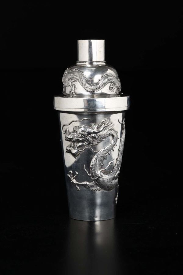 A silver shaker with dragons in relief, China, Qing Dynasty, 19th century