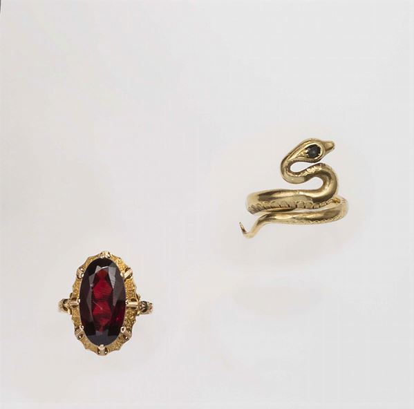 Two gold and garnet rings. Mario Buccellati. Fitted case