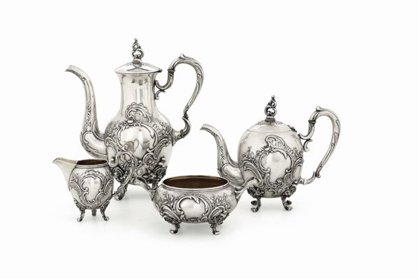 A tea and coffee set made up of a coffee pot, a teapot, a milk jug and a sugar bowl in molten, embossed, chiselled and gilded silver, Moscow 19th-20th century with stamps for Atelier Fabergè.