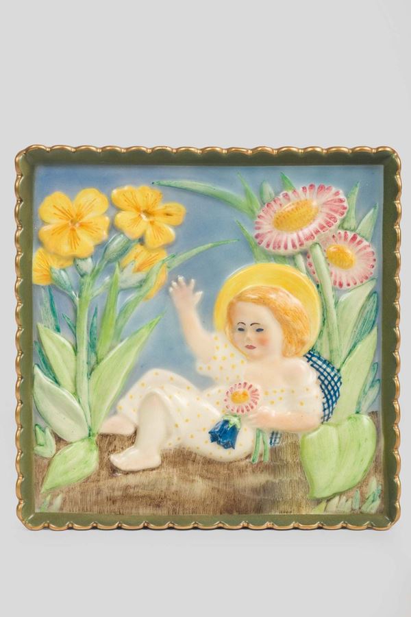 Lenci, Torino, 1950 ca. A briquette with a depiction of Baby Jesus in a garden, earthenware ceramics with a polychrome and gilded decor