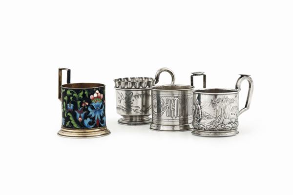 A group of four cup holders in molten, embossed, chiselled and enameled silver. Three with stamps for the city of Moscow from the last quarter of the 19th century, one with an unidentified Russian stamp.