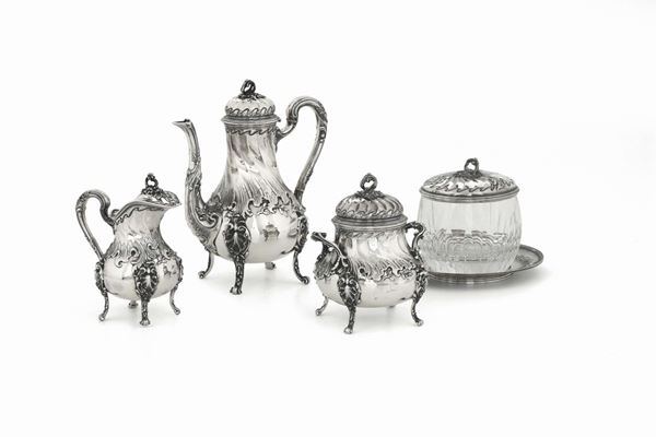 A tea and coffee set made up of a teapot, a coffee pot, a milk jug, a sugar bowl and a biscuit jar in molten, embossed and chiselled silver and ground glass.
