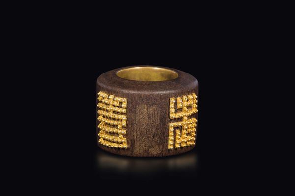 A wooden archer ring with golden details, China, Qing Dynasty, 19th century