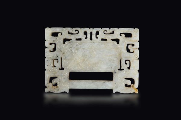 An archaic style white and russet jade belt buckle, China, Qing Dynasty, 19th century