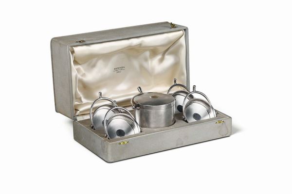 A smoking set in molten, gilded and chiselled silver within a case. Maison Hermes, Paris, France 20th century