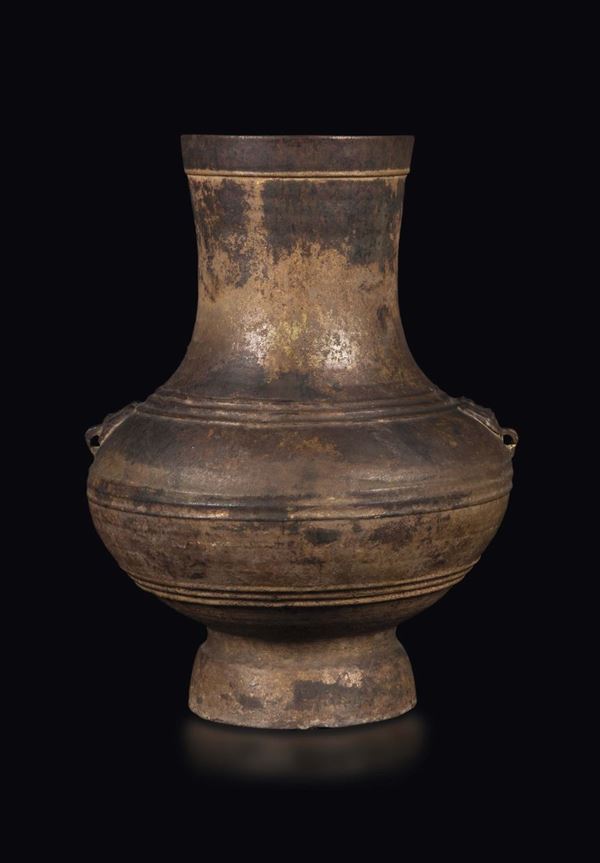 A pottery vase with mask handles, China, Han Dynasty (206-220)