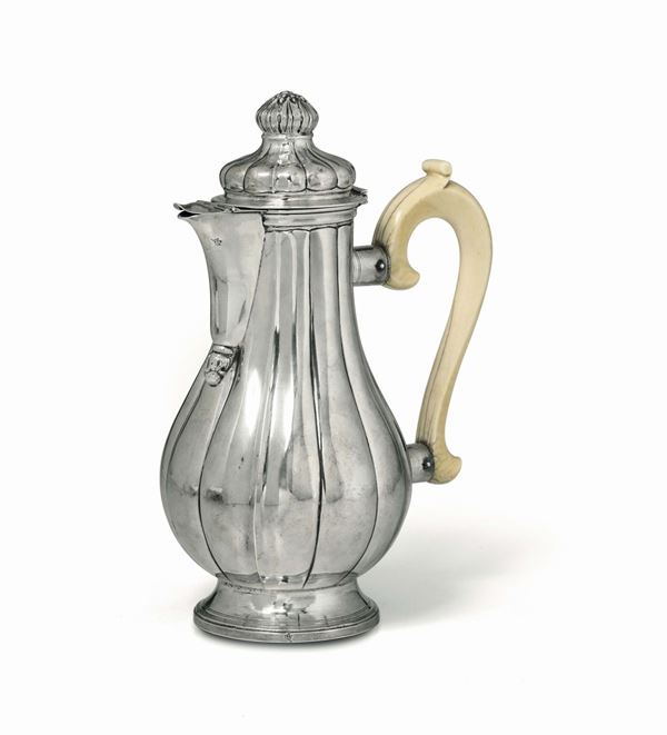 A coffee pot in molten, embossed and chiselled silver and ivory. Genoa, Torretta stamp with faded date