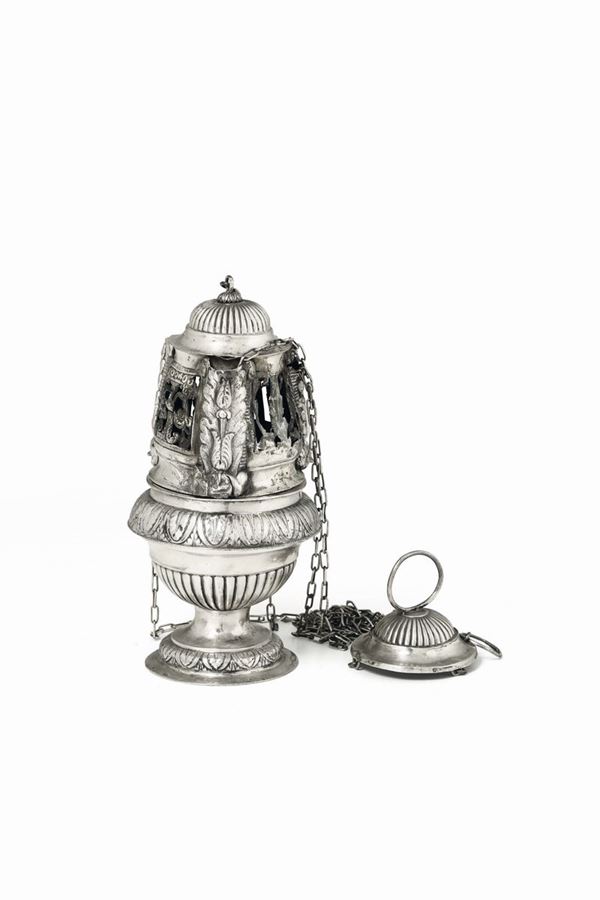 A censer in molten, embossed and chiselled silver. Genoa, 19th century, guarantee mark (Saint Maurice cross and coiled dolphin) and unidentified silversmith's stamp.